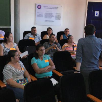 Facilitadores sentados poniendo atención a presentador