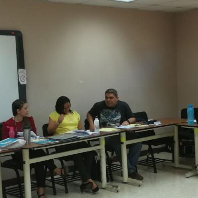 Dos mujeres y hombre sentados hablando
