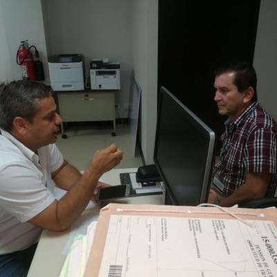 Dos hombres conversando en escritorio