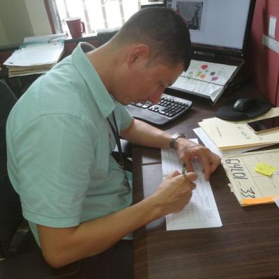 Hombre revisando información de folleto en su escritorio