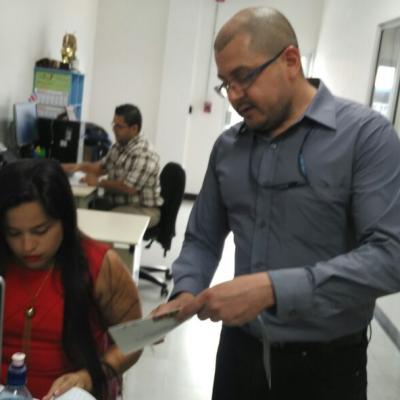 Hombre revisando folleto con mujer en escritorio