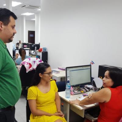 Tres personas conversando en oficina