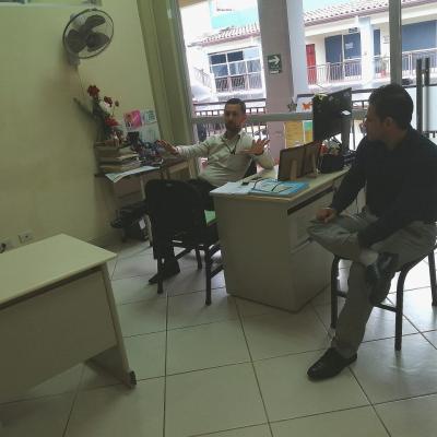 Dos hombres conversando en oficina