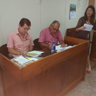 Dos hombres sentados leyendo documentos