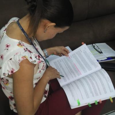 Mujer sentada leyendo un documento 